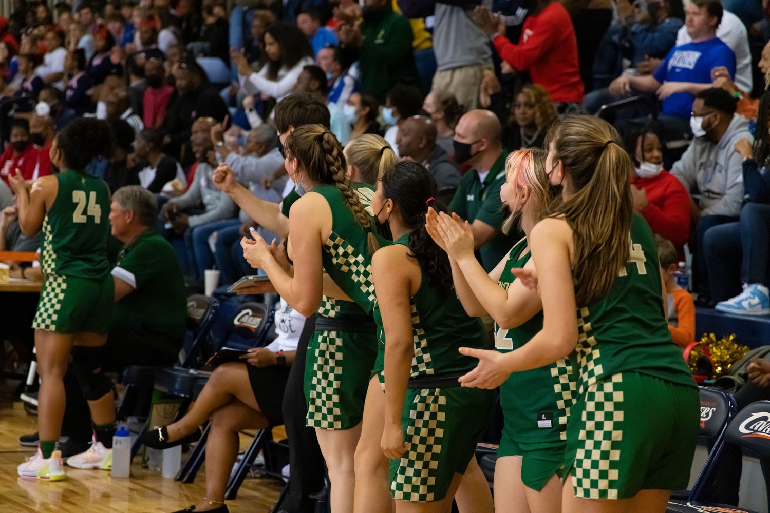 The Northwood women's basketball team bench explodes in cheers during the Chargers' 51-50 upset of the Terry Sanford Bulldogs in the 3A East Regional Championship on Saturday.